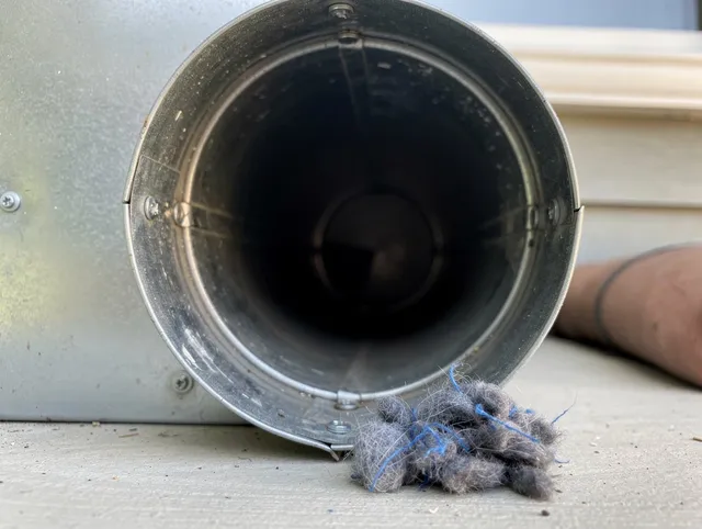 Security-Widefield Dryer Vent Cleaning technician using specialized equipment to clear severe dryer vent blockage in Security-Widefield